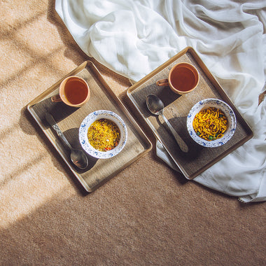 Set of three brown serving trays of different sizes on a white background